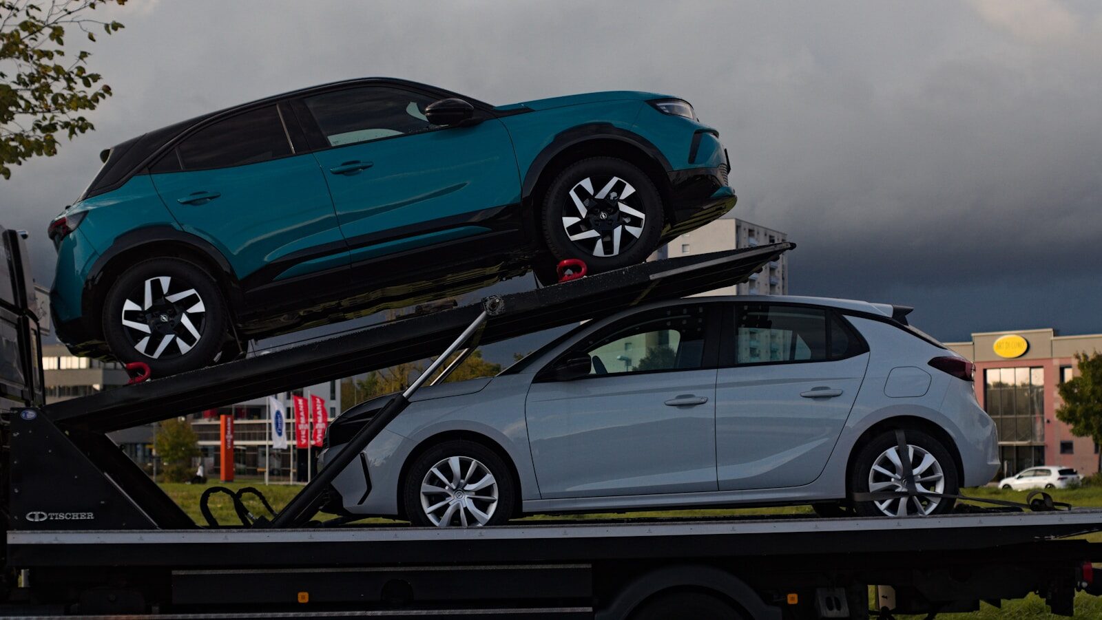 Two cars loaded onto a car carrier truck