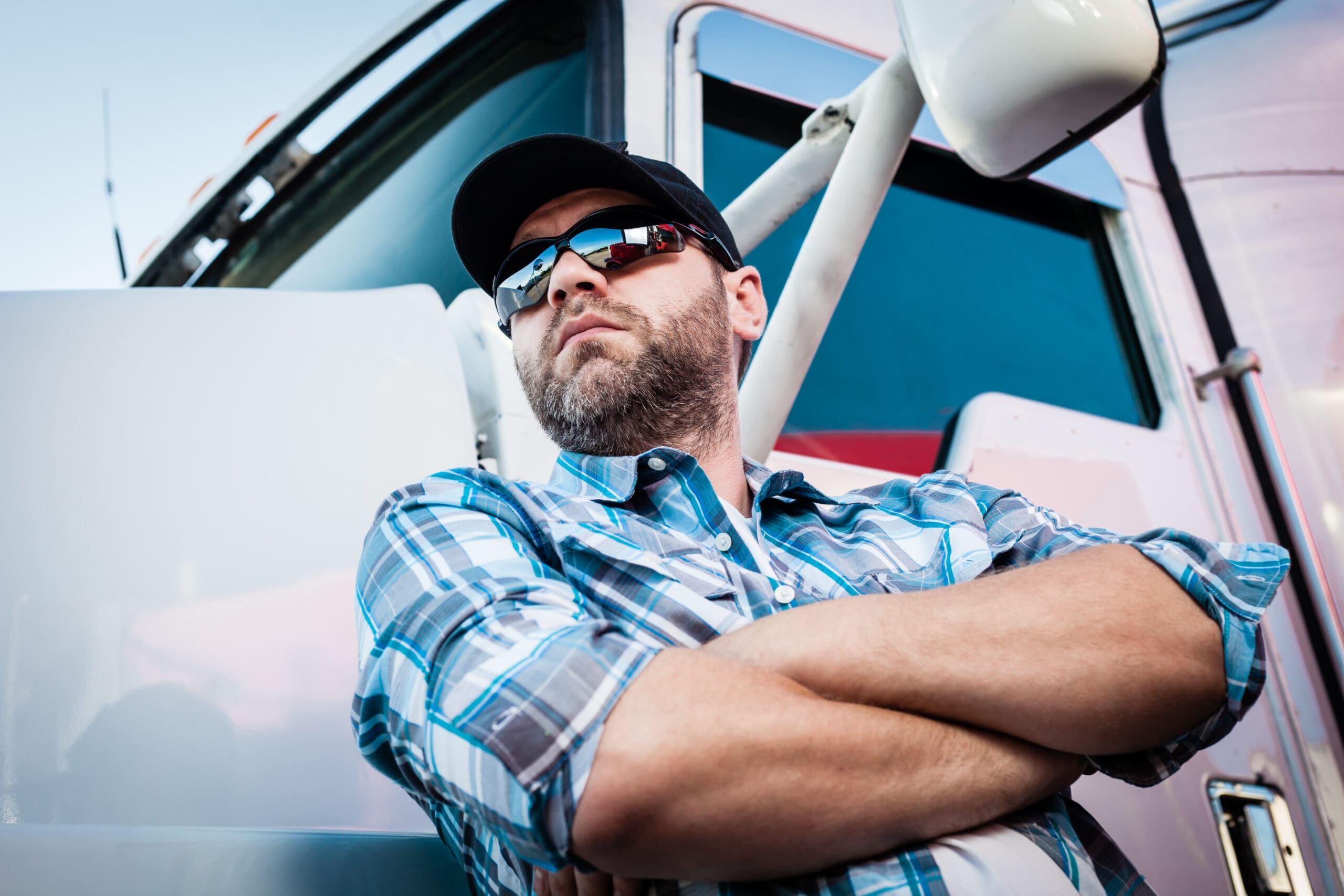 Owner-operator standing beside his semi truck after starting a new trucking authority
